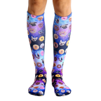 Pair of knee-high socks with a purple, pink, and blue galaxy print.  The print features various dog breeds and donuts. [lf]