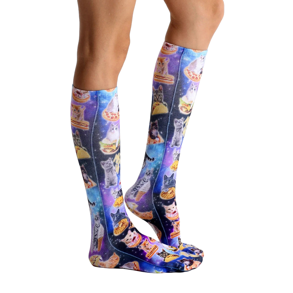Lifestyle shot showing the socks on a person's legs, highlighting their length and the vibrant print. [lf]