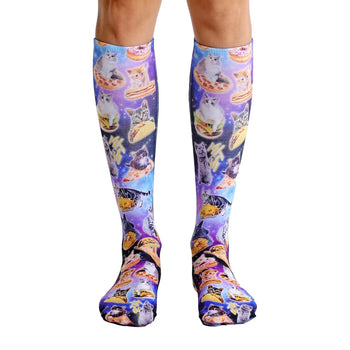 cat cravings knee-high unisex socks boast an all-over pattern of funny costume-clad cats eating various foods on a blue background.   