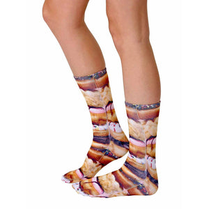 A pair of legs is shown from the knees down. The person is wearing a pair of socks that have a photorealistic print of Pop Tarts.
