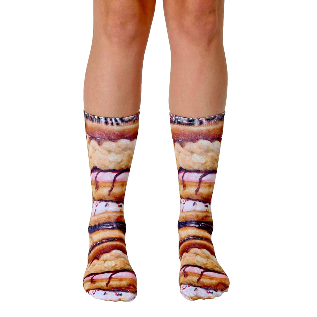 A pair of crew socks with a stacked donut design. The socks are primarily brown, pink, and white, with sprinkles. [lf]