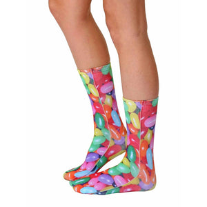 A pair of socks with a colorful pattern of jelly beans on a white background.