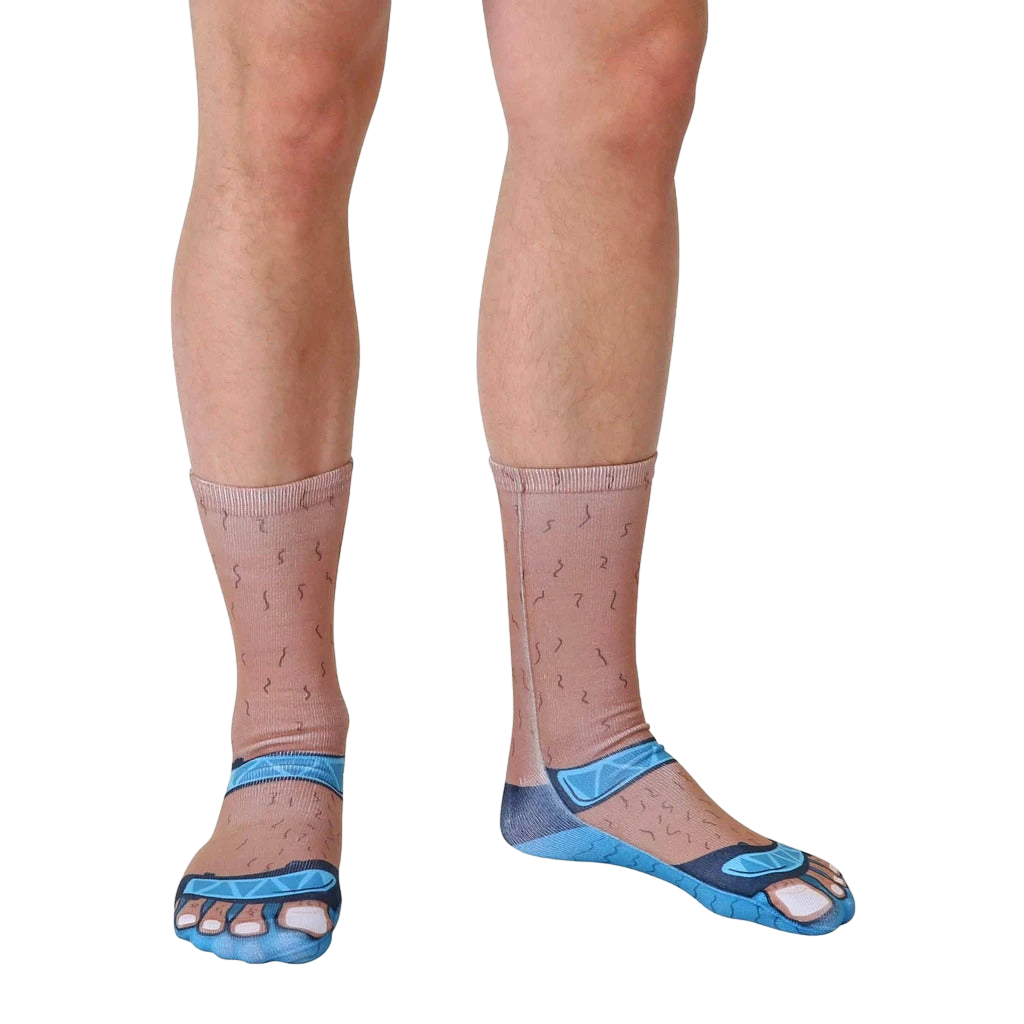Lifestyle shot: A person's legs wearing the Socks and Sandals Tan socks from the ankles down; the socks are angled slightly to the right. [lf]