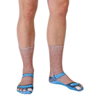 Lifestyle shot: A person's legs wearing the Socks and Sandals Tan socks from the ankles down; the socks are angled slightly to the right. [lf]