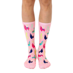 Pink crew socks with a fun pattern of colorful llamas and cacti. [lf]