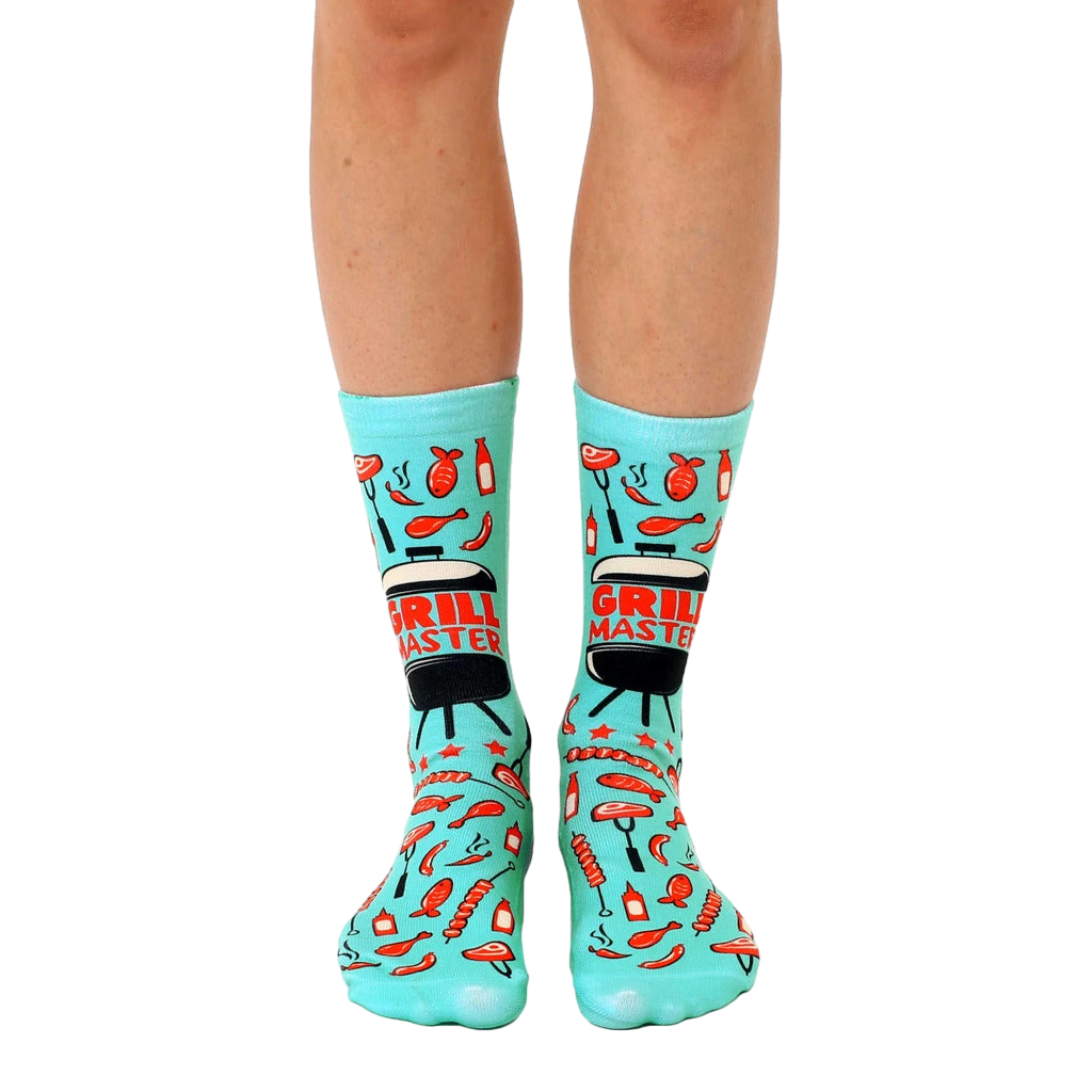 Teal crew socks with a fun BBQ design. Features images of grilled meats, grilling tools, and the phrase 'Grill Master'. [lf]