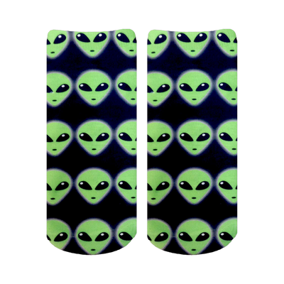 Pair of ankle socks with an all-over pattern of light green alien faces on a navy blue background.