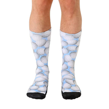 Crew socks with a light blue background and a repeating pattern of gray volleyballs.  Black reinforced toe and heel.