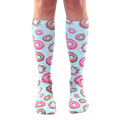 Pair of pastel blue knee-high socks adorned with a pattern of pink and chocolate donut illustrations. [lf]