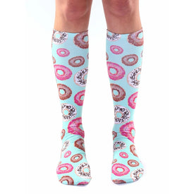 light blue knee-high socks adorned with sprinkled donuts in various colors including pink and brown. unisex sizing.   