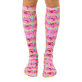 Pair of knee-high socks featuring a pink donut pattern on a light blue background. [lf]