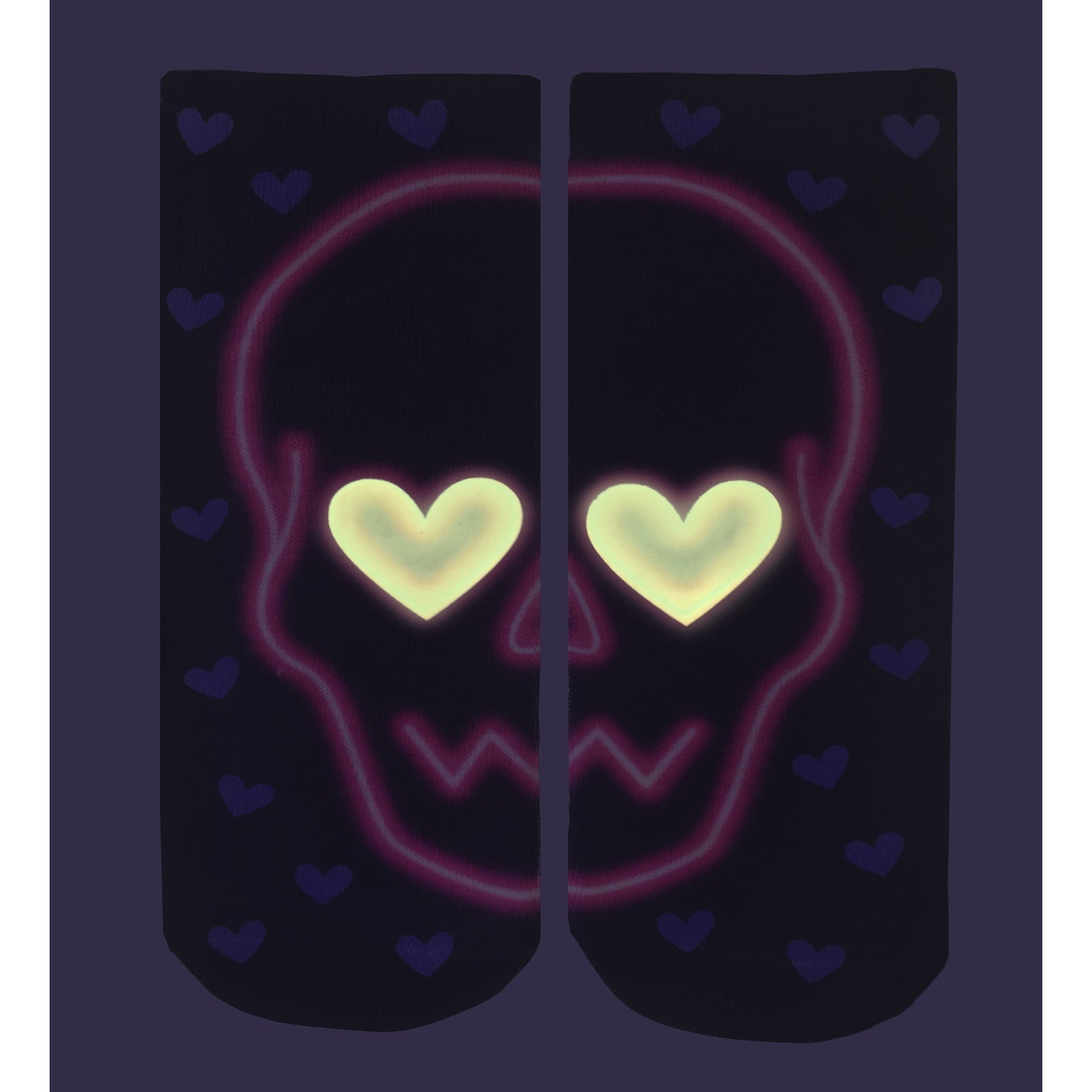 Close-up of the Love Skull Glow socks in the dark, showing the glow-in-the-dark effect. [lf]