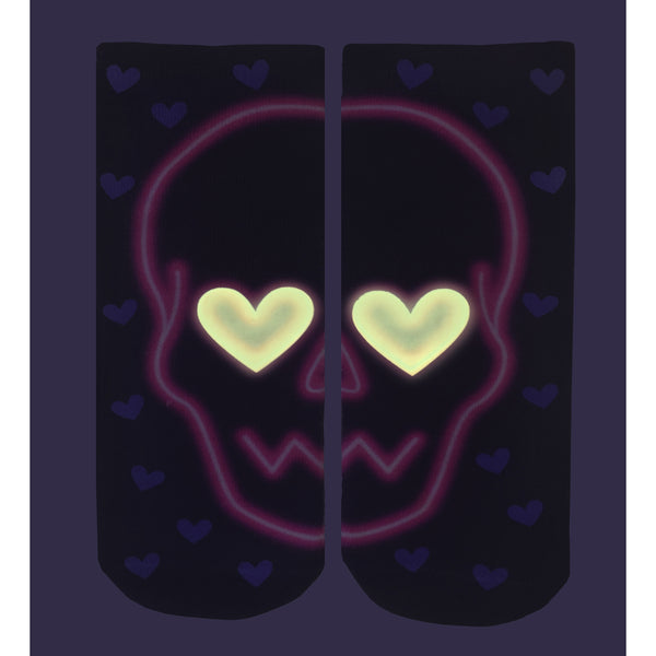 Close-up of the Love Skull Glow socks in the dark, showing the glow-in-the-dark effect. [lf]
