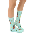 Lifestyle shot: A person's legs wearing the Googly Pineapple socks, showcasing how they look when worn. [lf]