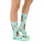 Lifestyle shot: A person's legs wearing the Googly Pineapple socks, showcasing how they look when worn. [lf]