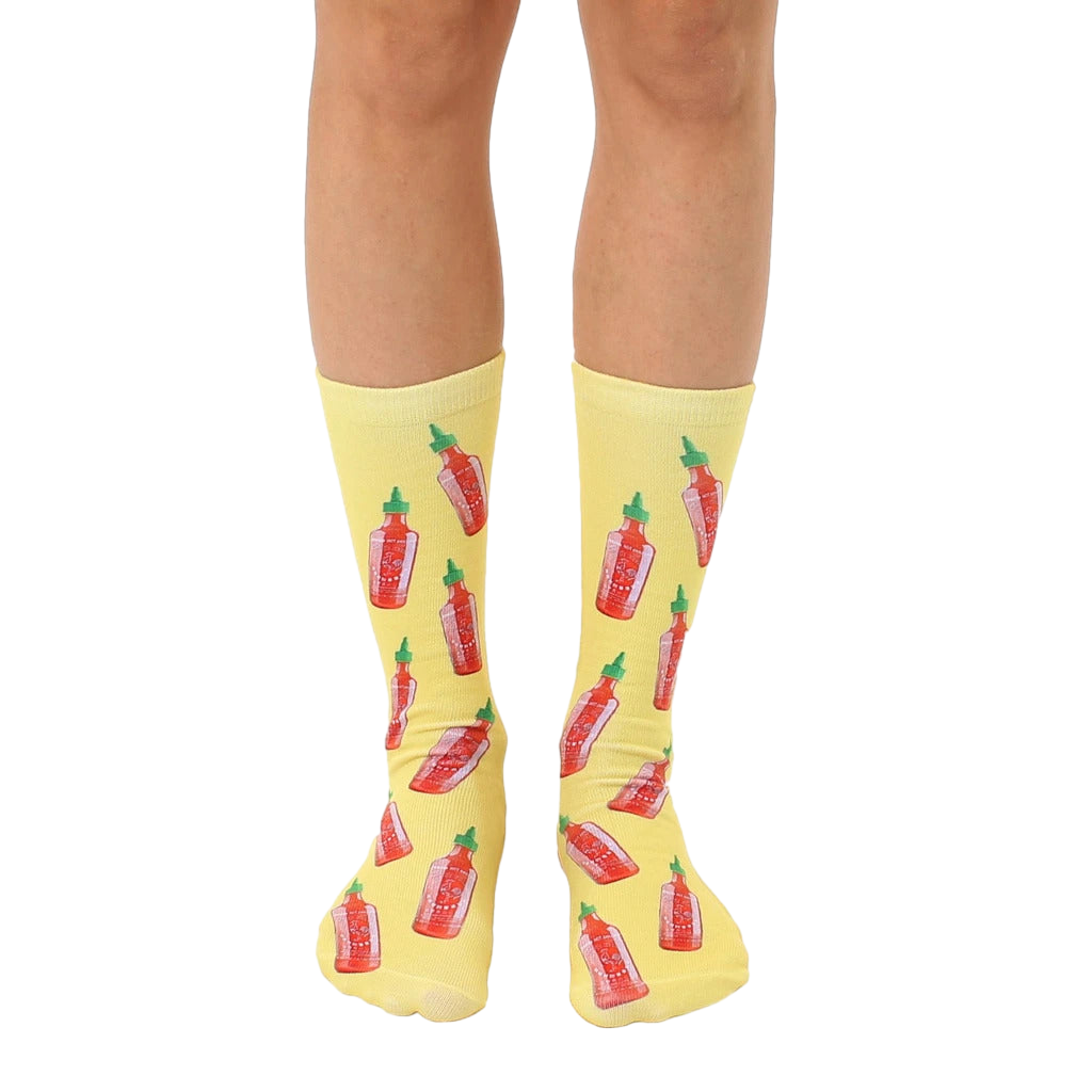 Crew socks in yellow with a repeating pattern of red and green hot sauce bottles. Fun and quirky design. [lf]