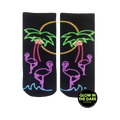 Pair of black ankle socks with a neon glow-in-the-dark design. Flamingos, palm trees, and a sunset are depicted in pink, purple, and green.