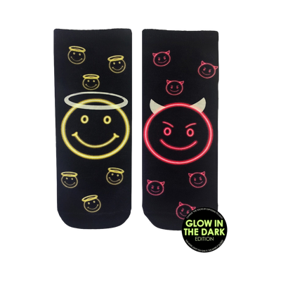 Pair of black crew socks with a glow-in-the-dark design. One sock features a neon yellow angel smiley face, the other a neon pink devil smiley face.