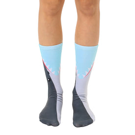 shark bite crew socks for men and women, light blue water with shark fin at top, dark gray shark's face with open mouth and sharp teeth at bottom  