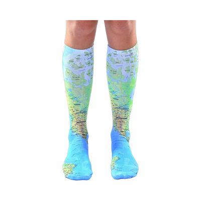 Pair of light blue knee-high socks with a detailed world map design.  The map features green and brown landmasses and blue oceans.