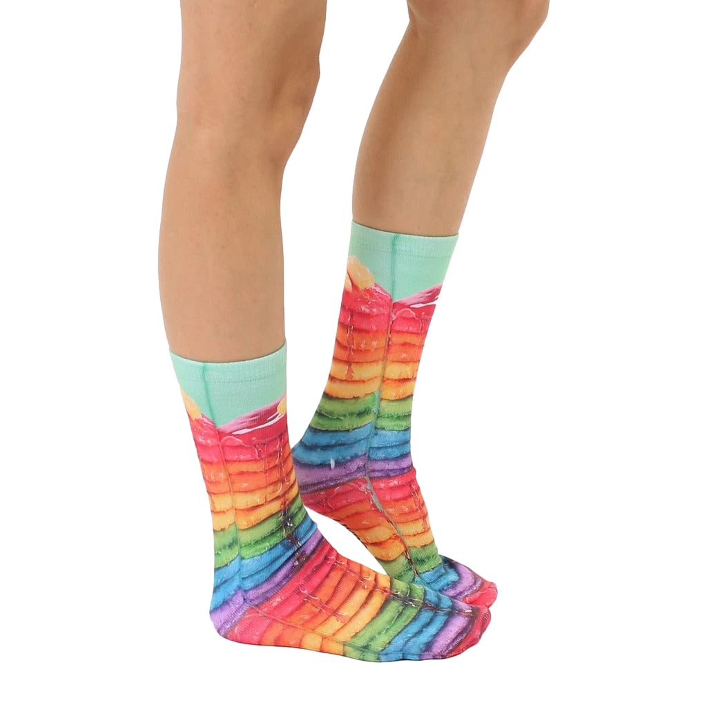 Lifestyle shot of Rainbow Pancake socks on a person's feet, showing the socks from the side. [lf]