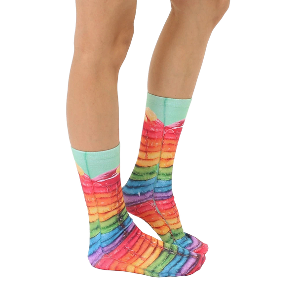 Lifestyle shot of Rainbow Pancake socks on a person's feet, showing the socks from the side. [lf]