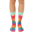A pair of crew socks showcasing a whimsical design of rainbow-colored pancakes with syrup.  Mint green cuff. [lf]