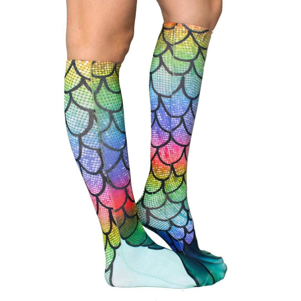 Close-up view of rainbow mermaid scale knee-high socks. Shows detail of scale design and teal tail. [lf]