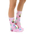 Lifestyle shot showcasing Cupcake Dream socks on a model's legs, highlighting the socks' vibrant colors and fun cupcake design. [lf]