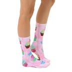 Lifestyle shot showcasing Cupcake Dream socks on a model's legs, highlighting the socks' vibrant colors and fun cupcake design. [lf]