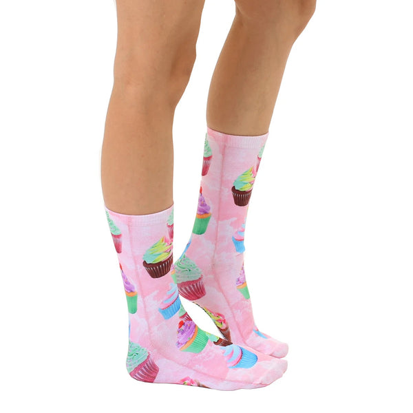 Lifestyle shot showcasing Cupcake Dream socks on a model's legs, highlighting the socks' vibrant colors and fun cupcake design. [lf]