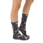 Lifestyle shot showing the T-Rex Fossil socks on a person's legs, from the side, providing a view of the sock pattern. [lf]