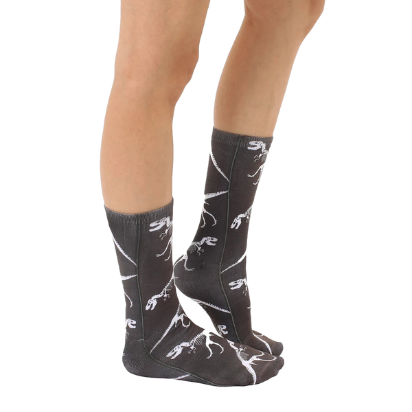Lifestyle shot showing the T-Rex Fossil socks on a person's legs, from the side, providing a view of the sock pattern. [lf]