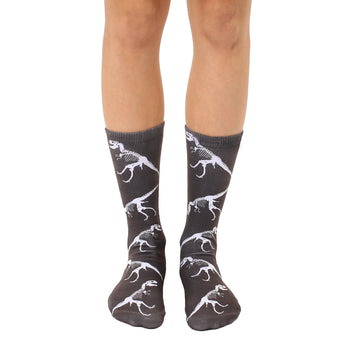 dark gray crew socks with a striking pattern of white t-rex dinosaur fossils. for men and women, they're dino-mite!    