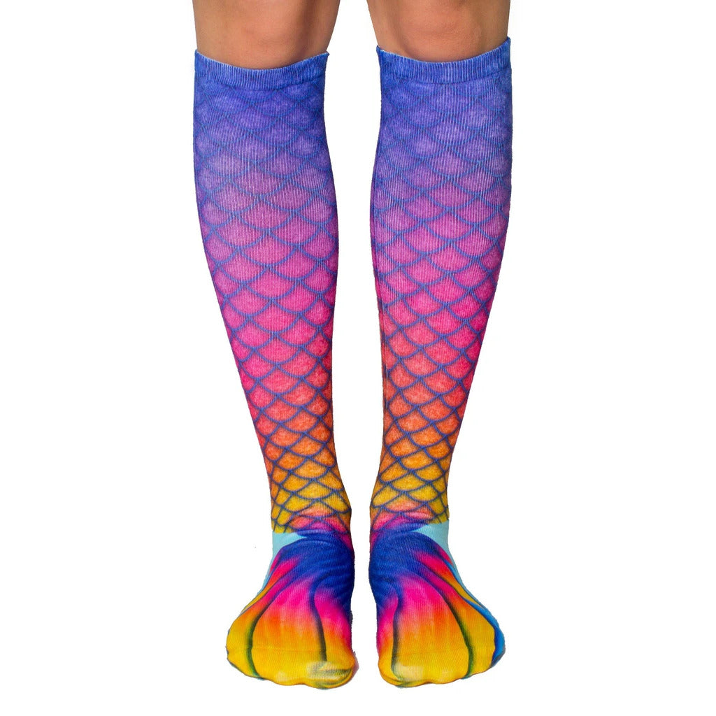 Pair of women's knee-high socks with a mermaid tail design.  Colors are predominantly purple, pink, and orange, featuring a scale pattern. [lf]