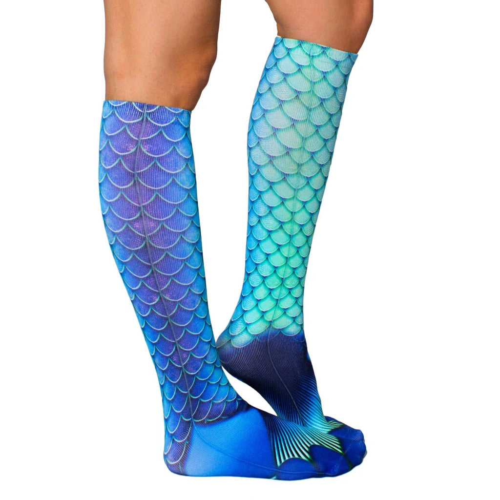 Close-up view of a single Mermaid Blue sock, showcasing the detailed scale pattern and vibrant color transitions. [lf]
