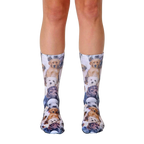 A pair of crew socks covered in an all-over print of adorable puppies in various breeds and colors. The socks are mainly white with brown, tan, and black puppies. [lf]