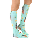 Lifestyle shot showing the Googly Pineapple knee-high socks on a person's legs, showcasing the sock's fit and pattern. [lf]