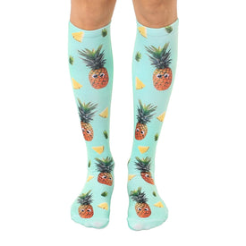 green knee-high socks with googly-eyed pineapples and pineapple slices design.   