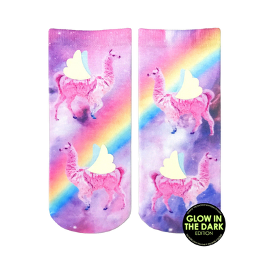 Crew socks showcasing pink llamas with wings against a purple galaxy background featuring a rainbow.  Glow-in-the-dark details.