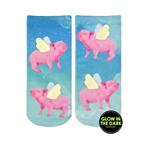 Lifestyle shot of the 'When Pigs Fly Glow' socks on a person's feet. The glow-in-the-dark detail is subtly visible.