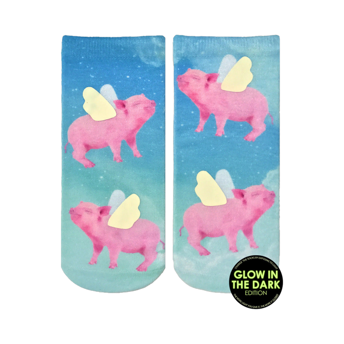 Lifestyle shot of the 'When Pigs Fly Glow' socks on a person's feet. The glow-in-the-dark detail is subtly visible.