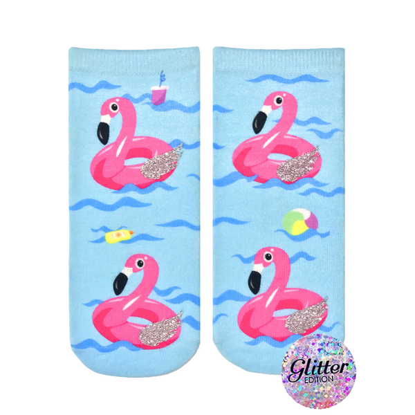 Crew socks featuring pink inflatable flamingos on a light blue wave background. Glitter accents add sparkle. Fun summer design. [lf]