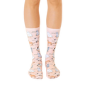 A pair of peach crew socks featuring illustrated cats of various breeds in soft blues and grays.  A fun and whimsical design! [lf]