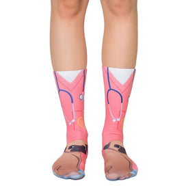 womens pink crew socks feature a whimsical pattern of cartoon pugs dressed as veterinarians.  