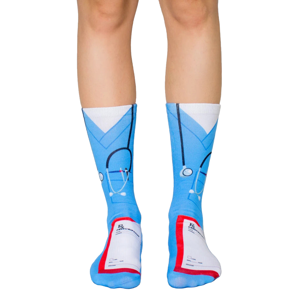 Crew socks in light blue, featuring a nurse's scrubs design, stethoscope, and prescription pad graphic. Fun and comfortable! [lf]
