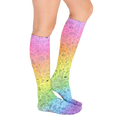 Lifestyle photo showing a person's legs wearing the rainbow doodle knee-high socks. [lf]