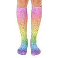 Pair of rainbow gradient knee-high socks with black doodle icons including peace signs, smiley faces, and other fun designs. [lf]