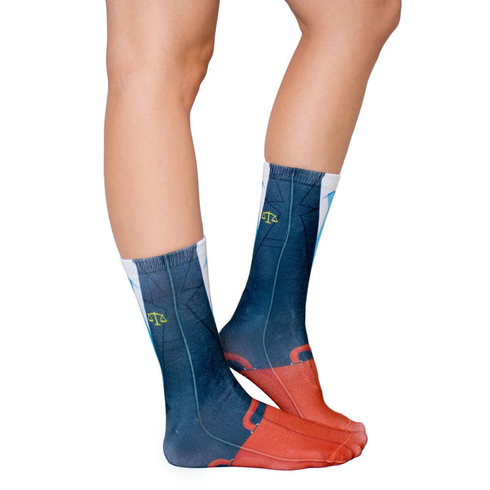 A pair of legs is shown from the knees down. The person is wearing a pair of socks that have a pattern of red briefcases on a blue background.