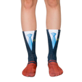 A pair of crew socks showcasing a navy suit and blue tie design.  The socks have red shoe details and yellow scales of justice on the tie. [lf]
